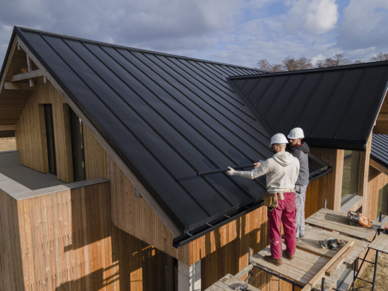 repair-specialist-measuring-roof - MidSouth Construction LLC Two repair specialists measuring a new roof