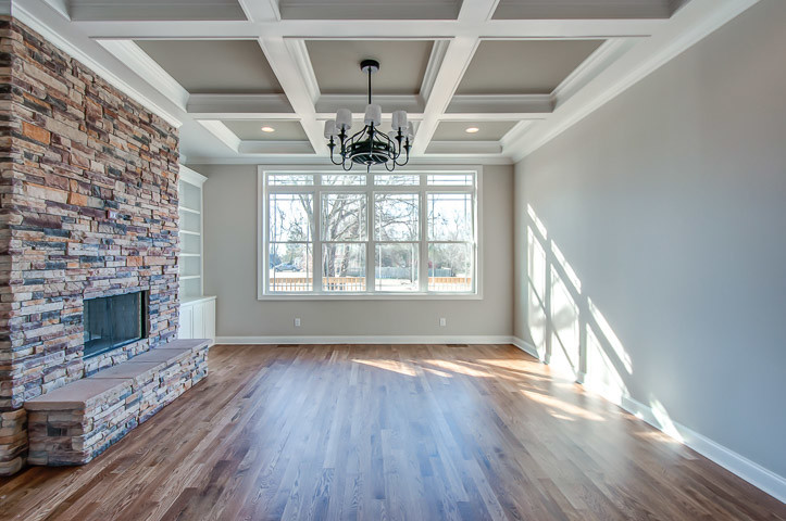 coffered ceilings with stacked stone fireplace and special walnut hardwood floors
