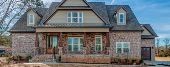 Brick two-story house with porch.