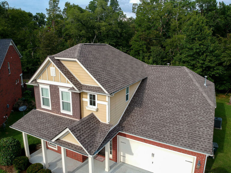 Aerial view of a house with new roof.