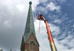 Church steeple repair on historic copper spire by roofing contractors midsouth construction