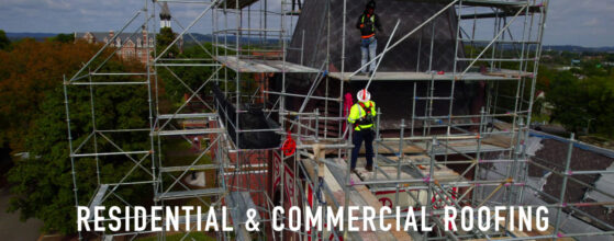 A group of people standing on top of scaffolding.