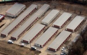 A group of storage units in the middle of a field.