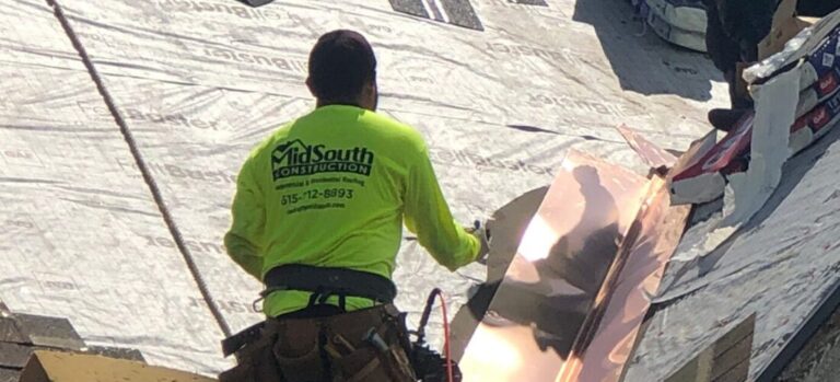 A MidSouth Construction worker installing copper flashing on a roof.