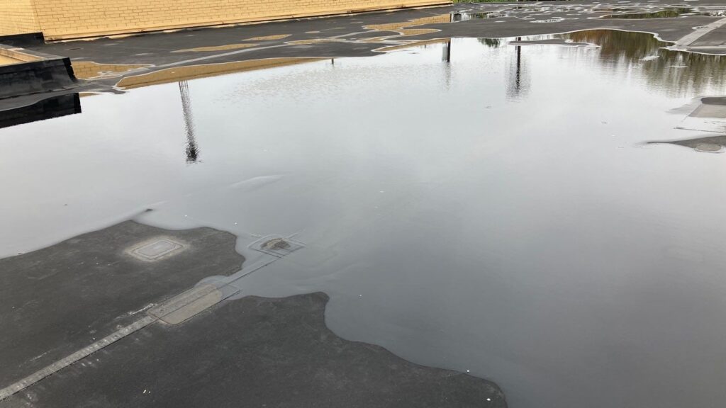 commercial roof inspection shows ponding water - MidSouth Construction LLC Picture of ponding water on a commercial roofing which will lead to interior damage